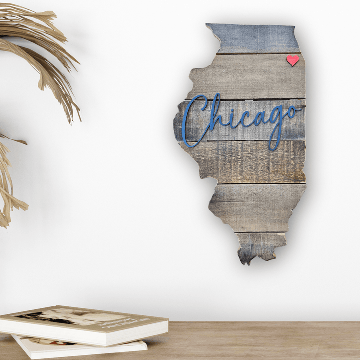 Wooden pallet wall art of Illinois shaped state with 'Chicago' and a heart on a white wall.