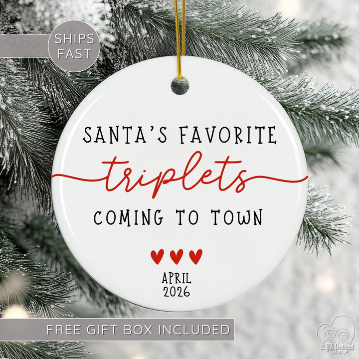 Christmas ornament with text 'Santa's Favorite Triplets Coming to Town' on a tree.