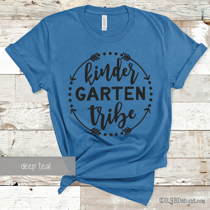 Blue t-shirt with 'KinderGarten Tribe' black text in a circle made of arrows and dots.