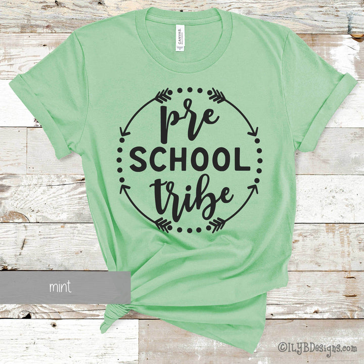 Mint green t-shirt with 'pre school tribe' black text in a circle made of arrows and dots.