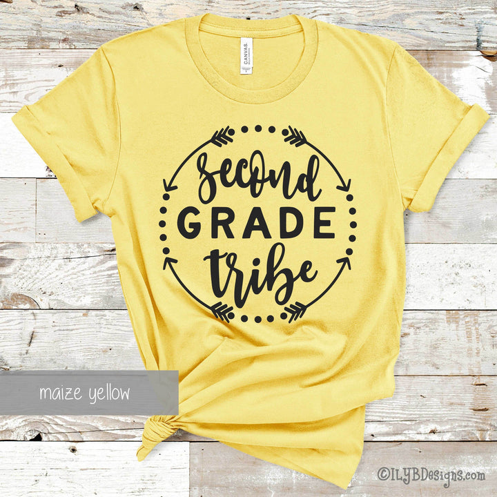 Yellow t-shirt with 'Second Grade Tribe' black text in a circle made of arrows and dots.