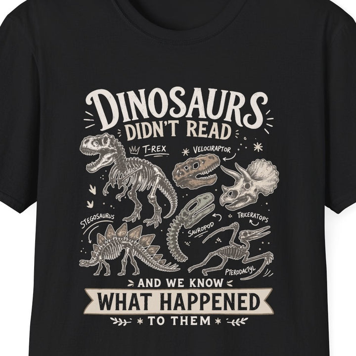 Black t-shirt with white text 'dinosaurs didn't read and we know what happened to them' on a white background