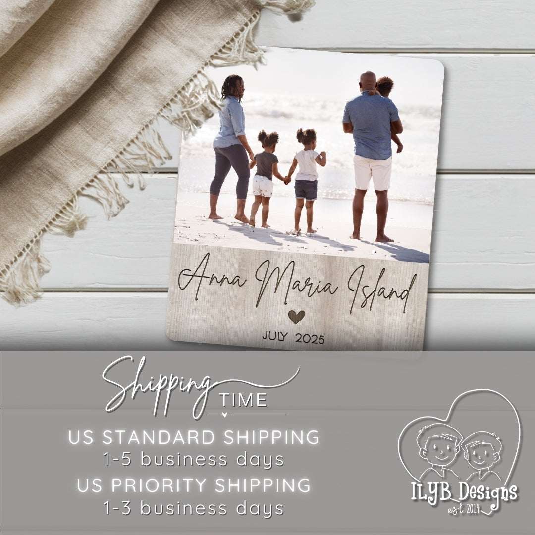 Photo board plaque with family photo and text 'Anna Maria Island, July 2025' on a wooden surface with a blanket.