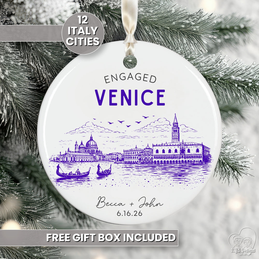 A round white ceramic Christmas ornament featuring a purple line art illustration of Venice, Italy, with the text 'ENGAGED VENICE' and personalized names/date. The ornament hangs from a white ribbon against a snowy Christmas tree background, with promotional text overlays that say '12 Italy Cities' and 'free gift box included'.