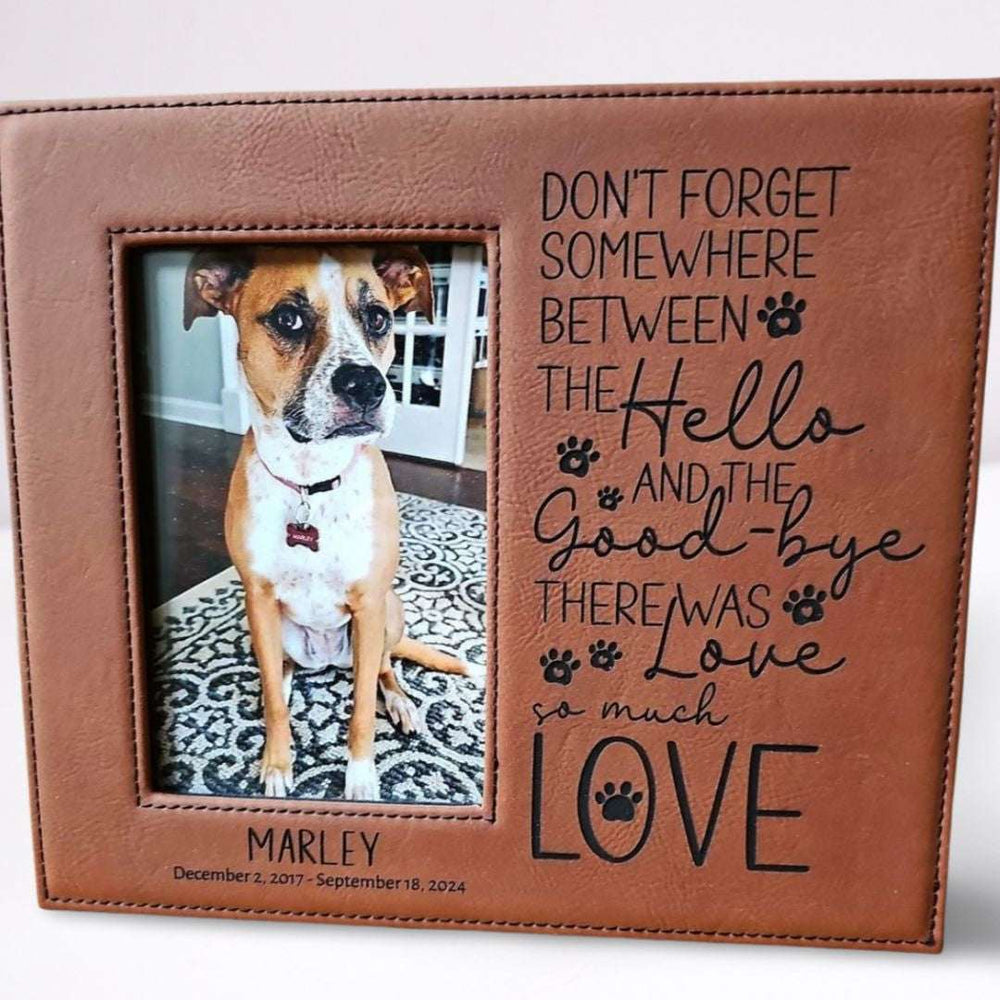 Brown leather photo frame with a dog picture and engraved text on a white background
