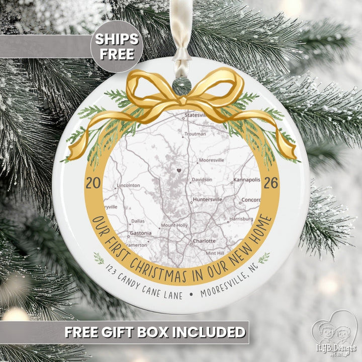 Personalized round Christmas ornament featuring a map of a home with a gold ribbon and green pine accents and the phrase &