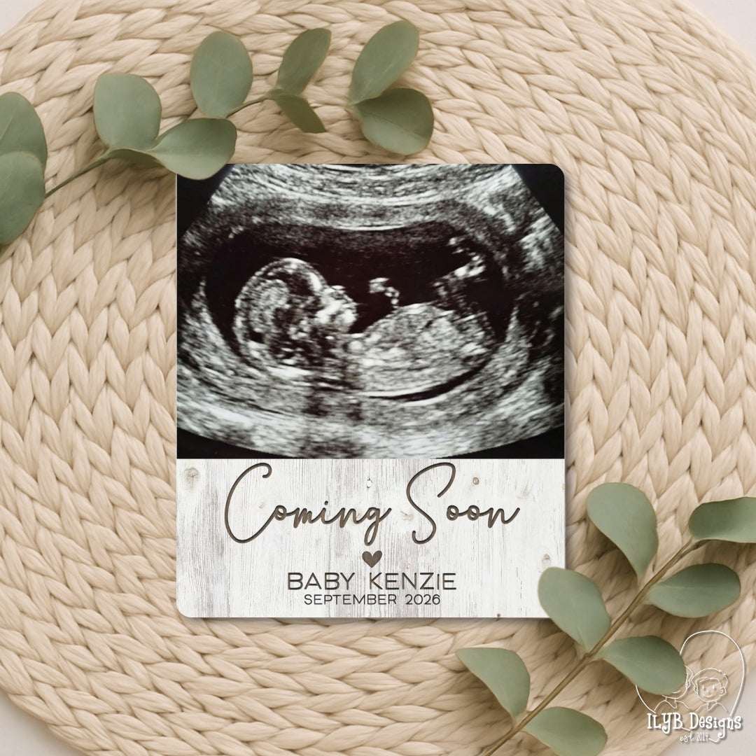 Photo board with baby ultrasound and "coming soon" with baby name and due date below in engraved text