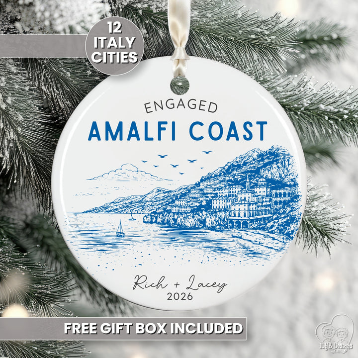 A round white ceramic Christmas ornament featuring a blue line art illustration of the Amalfi Coast in Italy, with the text &