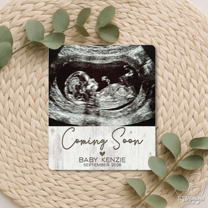 Photo board with baby ultrasound and "coming soon" with baby name and due date below in engraved text