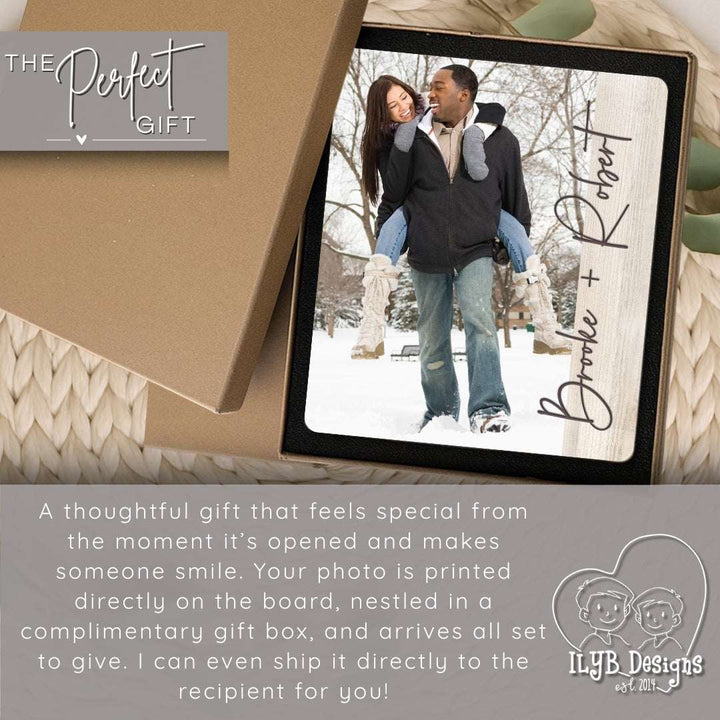 Personalized photo plaque with a couple in the snow, inside a gift box, on a textured surface.