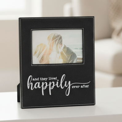 A black faux-leather picture frame with white stitching and the phrase &