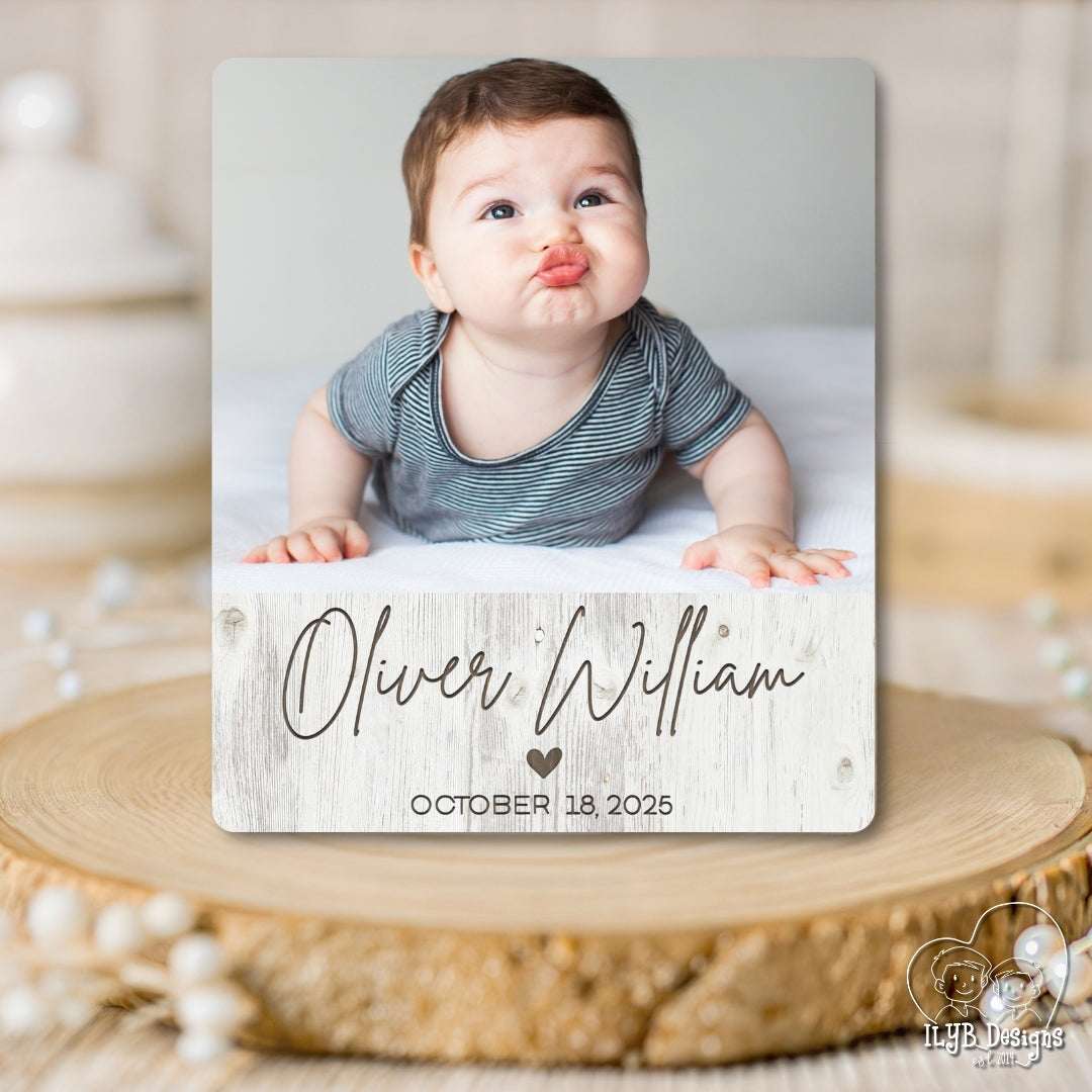 Baby photo with name and date on a wooden surface