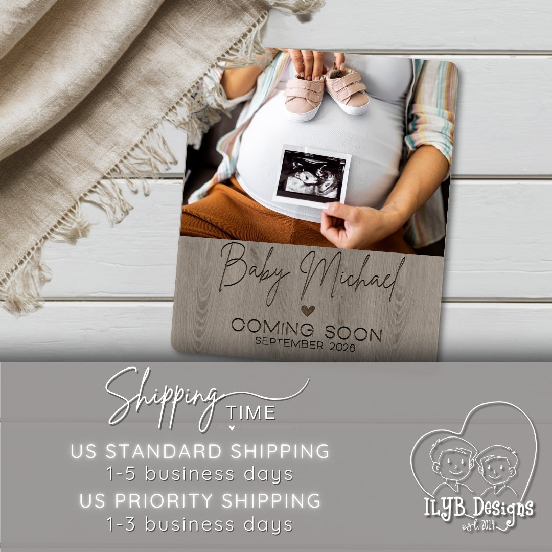 Wooden photo board with 'Baby Michael Coming Soon September 2023' text, ultrasound photo, and baby shoes on a wooden surface.