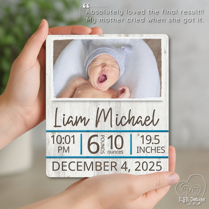 Baby photo frame with newborn baby's details held by a hand
