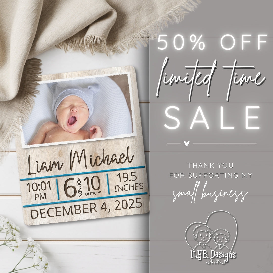 Wooden baby milestone board with newborn photo and birth details, promotional text for a sale on a gray background.