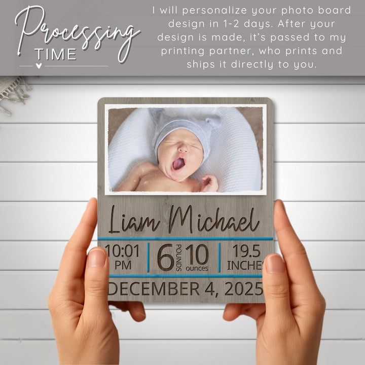 Personalized photo board with baby's name, birth details, and a photo of a baby held by hands on a light wooden background.