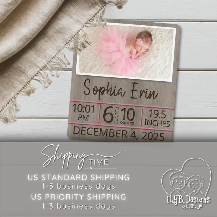 Wooden sign with baby photo, birth details, and shipping information on a wooden surface.