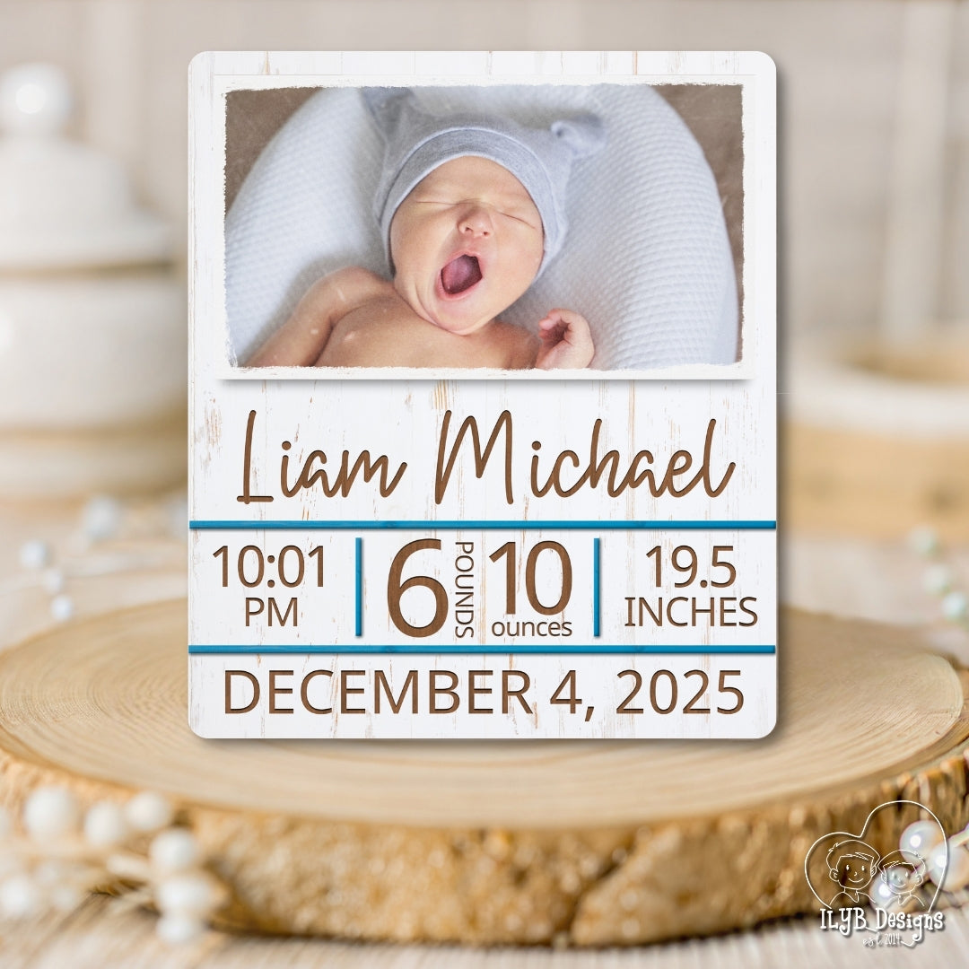 Baby photo with birth details on a wooden surface