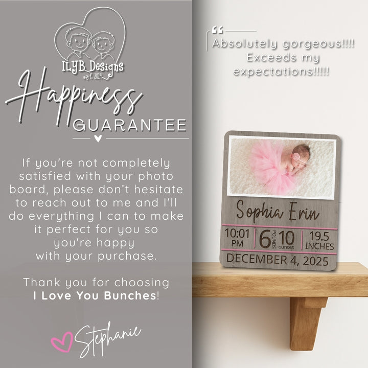 Baby photo board with text on a wooden surface, featuring a baby in a pink outfit.