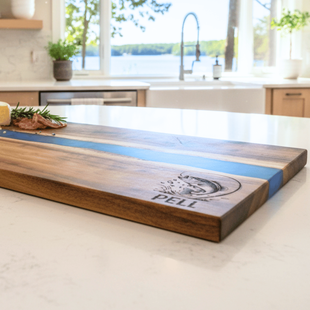 Wooden cutting board with blue resin inlay on a kitchen counter