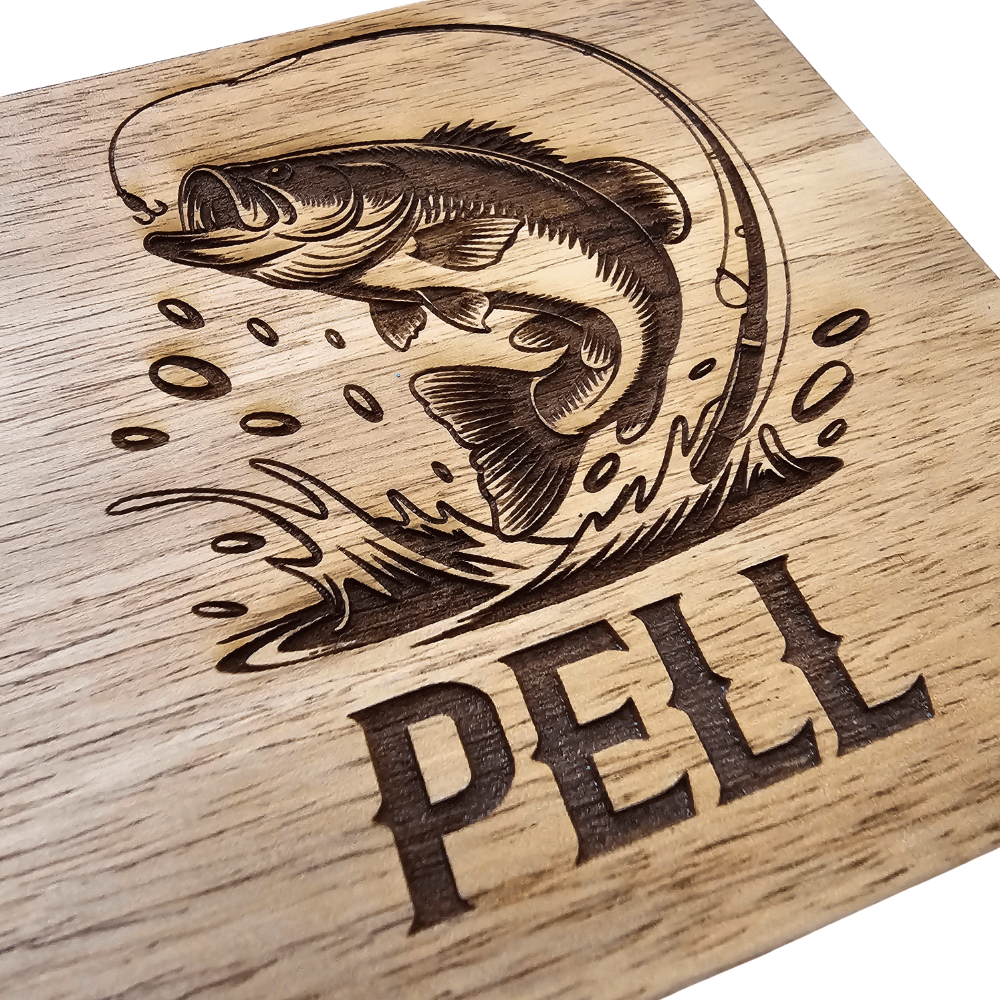 Close up of Wooden cutting board engraving of a fish and 'PELL' text