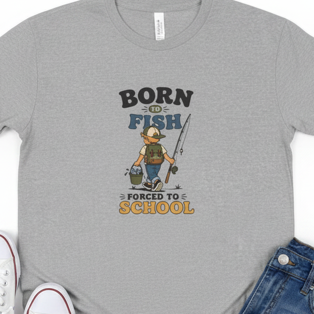 A heather gray crewneck t-shirt featuring a cartoon graphic of a boy fishing and carrying a bucket, with the text &
