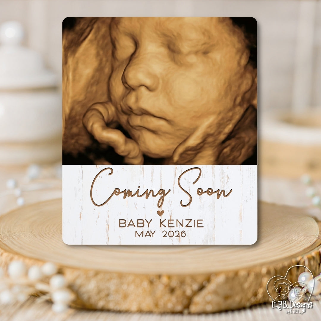 Baby photo gift with ultrasound photo and 'Coming Soon' text on a wooden surface.
