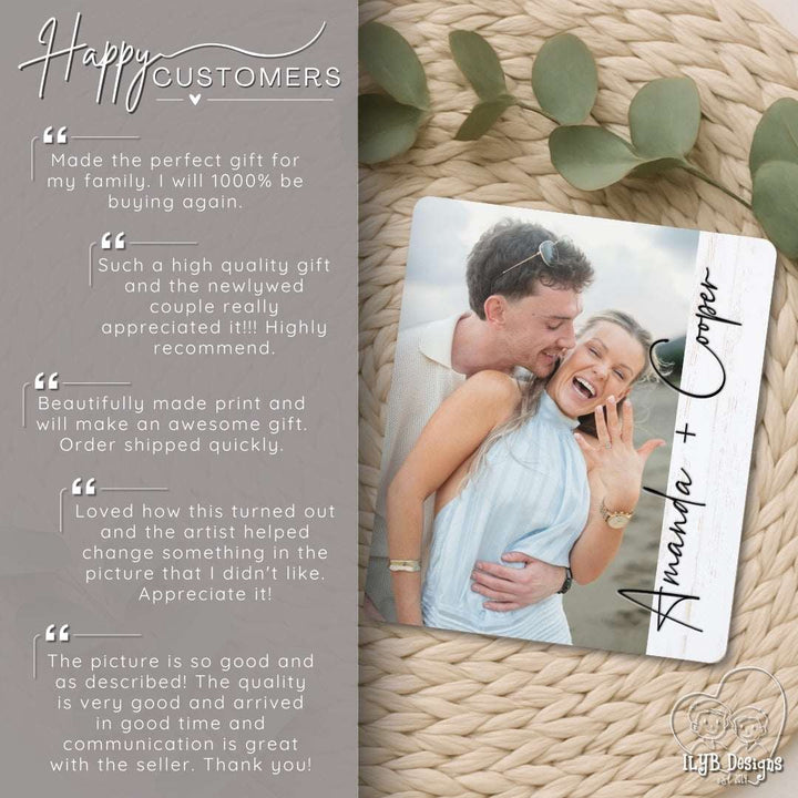 Personalized wood photo print of a couple with engraved names on a textured surface with green leaves.