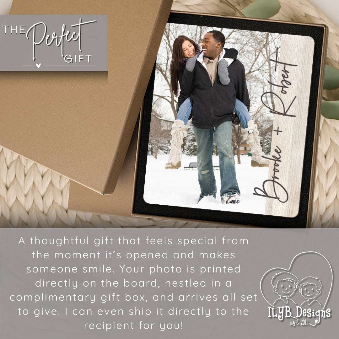 Personalized photo plaque with a couple in the snow, inside a gift box, on a textured surface.