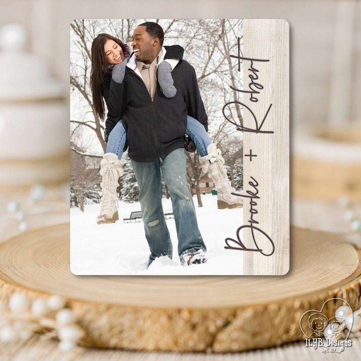 Personalized photo plaque with a couple in the snow and decorative text on a wooden surface.