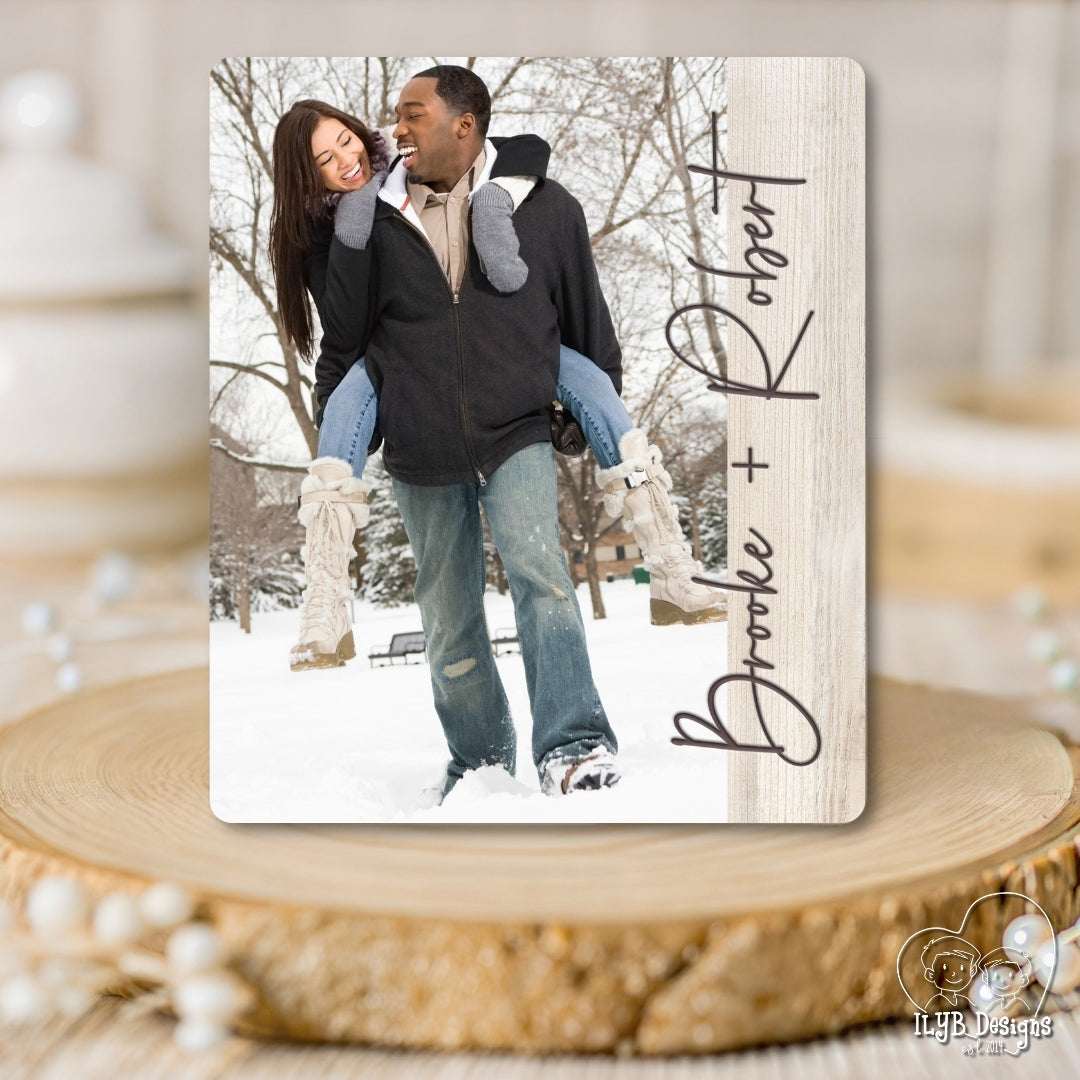 Personalized photo plaque with a couple in the snow and decorative text on a wooden surface.