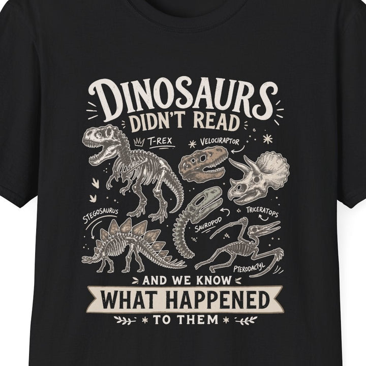 Black t-shirt with white text 'dinosaurs didn't read and we know what happened to them' on a white background