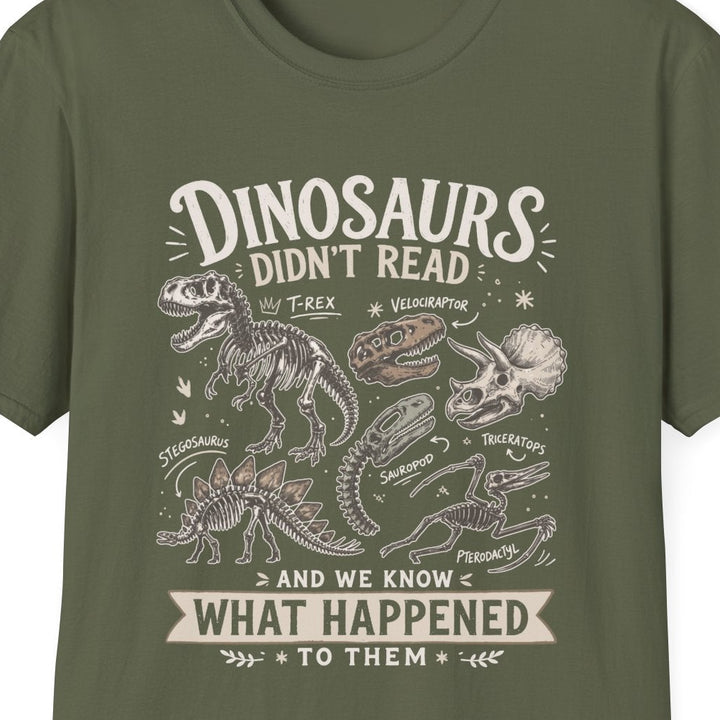 An olive green short-sleeve crewneck t-shirt with a vintage-style dinosaur graphic and text on the front, displayed against a solid white background.