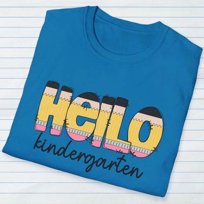 Folded teal personalized teacher shirt that says hello in pencil shaped letters and kindergarten in black script underneath.