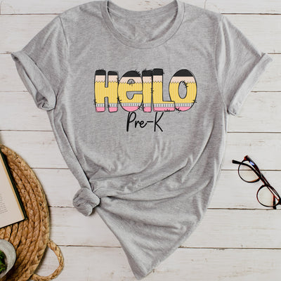 Athletic gray personalized teacher shirt with hello in pencil letters and pre k in black script underneath.