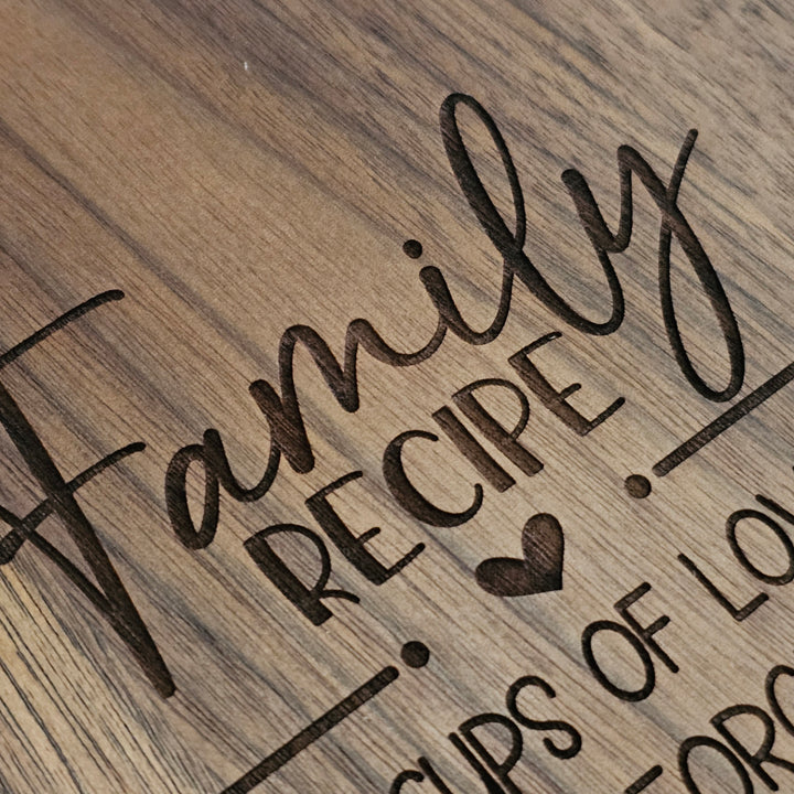 Close-up of a wooden surface with engraved text reading &