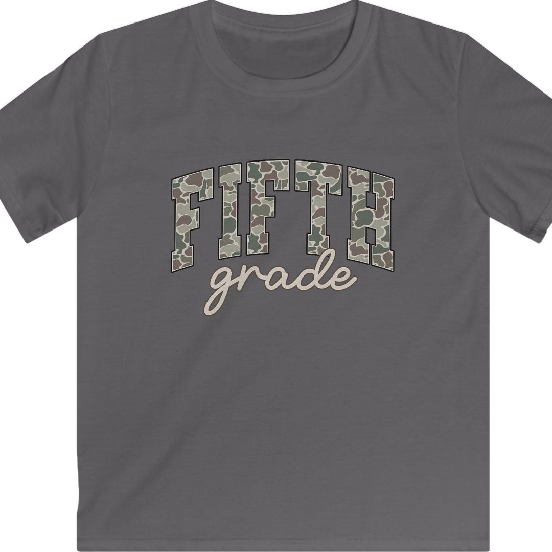 A dark gray short-sleeve t-shirt with a graphic on the chest reading 'FIFTH grade'. The letters 'FIFTH' are filled with a green and brown camouflage pattern, while 'grade' is written below in a light beige script font.