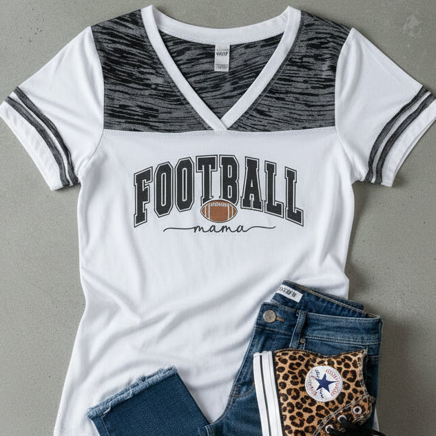 A white short-sleeve V-neck t-shirt with a black and gray patterned yoke, featuring &