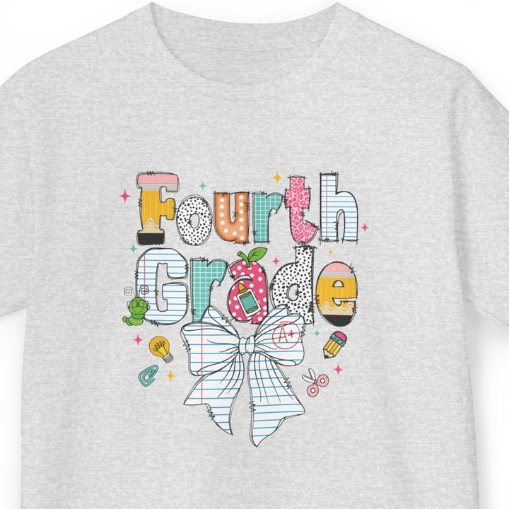 A light heather gray short-sleeve t-shirt with a colorful graphic on the front that reads 'Fourth Grade' in playful hand-drawn lettering, decorated with a white bow, and small school doodles, shown against a plain white background.