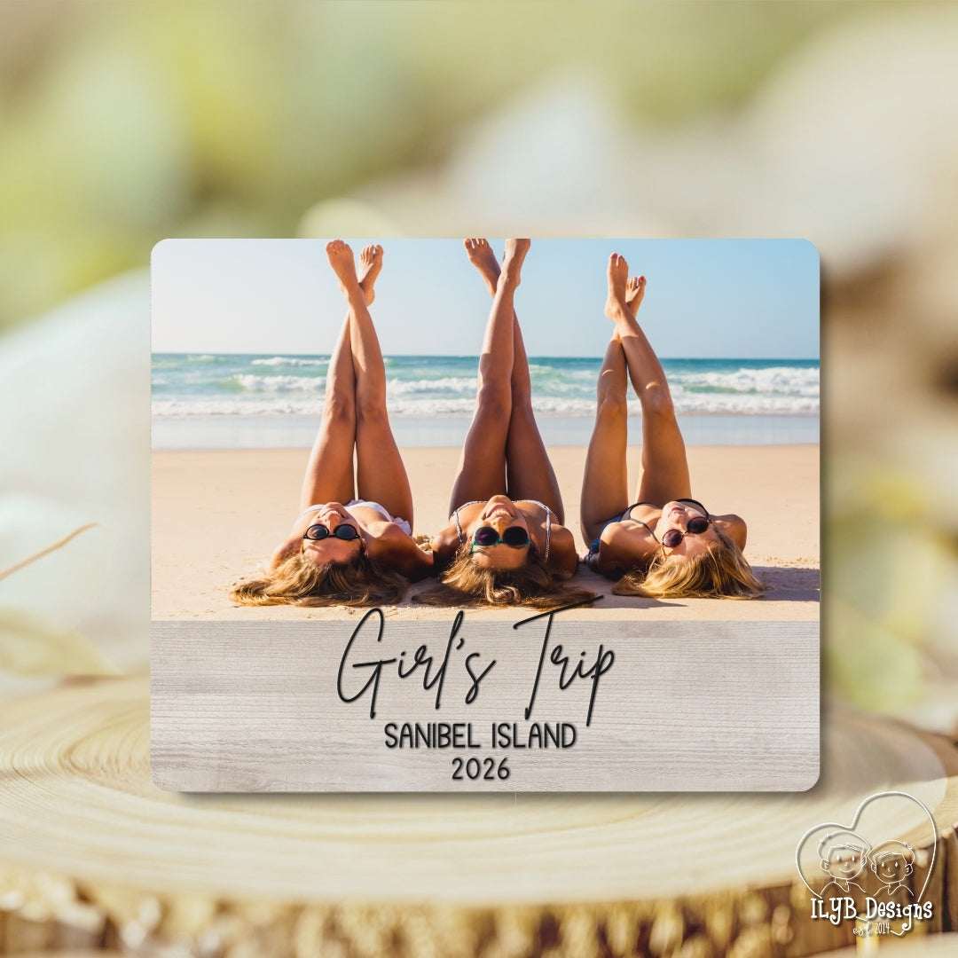 Photo plaque with a photo of three people lying on a beach and text 'Girl's Trip Sanibel Island 2026'.