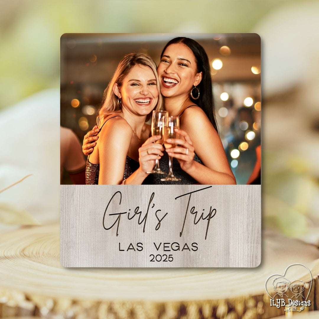 Two women celebrating with champagne glasses on a 'Girl's Trip Las Vegas 2025' photo plaque.