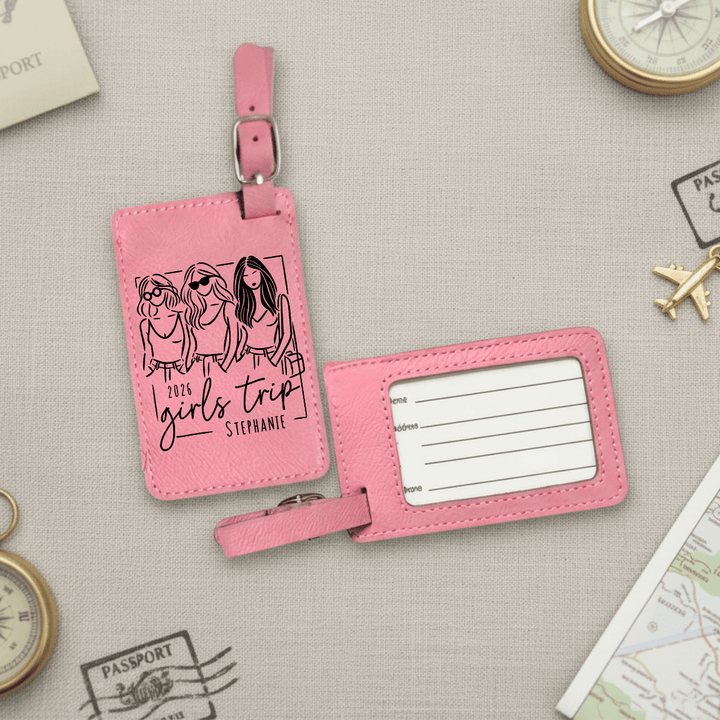 Pink luggage tag with '2026 Girls Trip' design on a travel-themed background