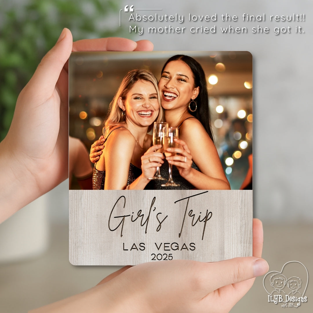 Two women holding glasses of champagne with a 'Girl's Trip Las Vegas 2025' card.