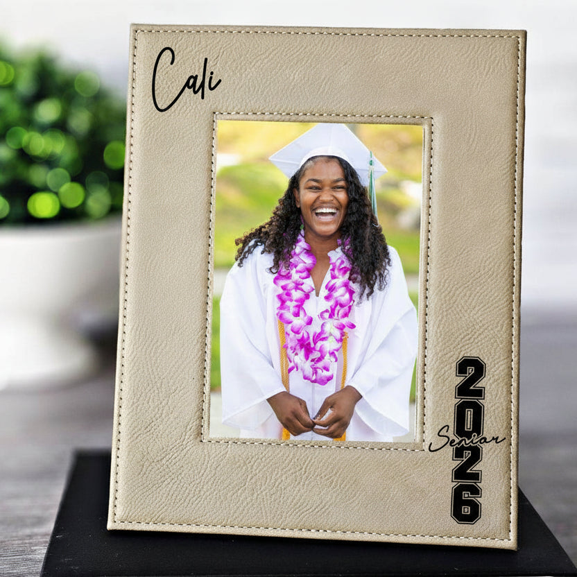 Graduation-themed photo frame with a picture of a graduate wearing a cap and gown.