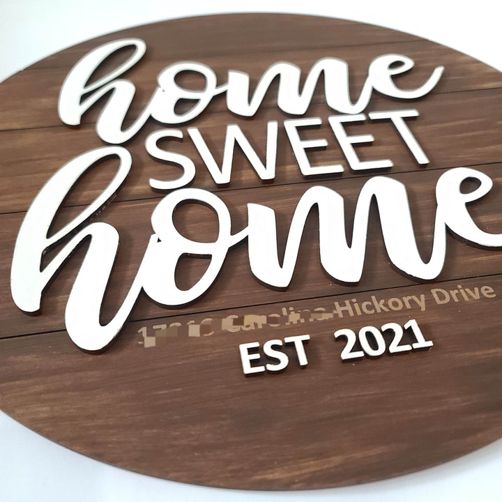 Wooden sign with 'home SWEET home' and 'EST 2021' text on a white background