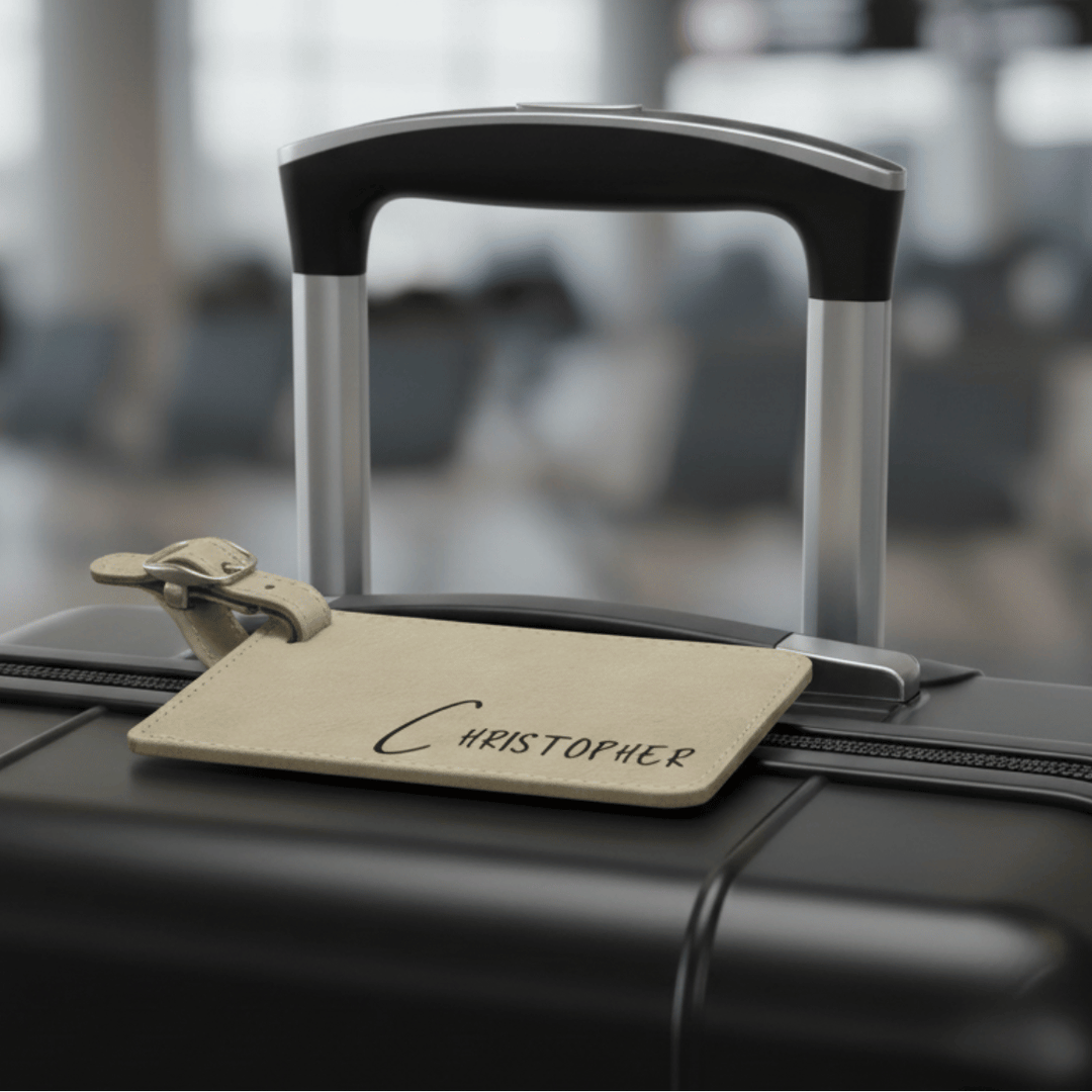 Black suitcase with a name tag labeled 'Christopher' in an airport setting