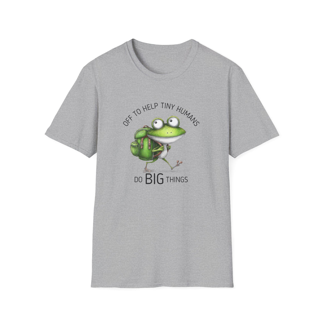 A light gray heather crewneck t-shirt featuring a cartoon graphic of a green frog wearing a backpack, with the text 'OFF TO HELP TINY HUMANS' above and 'DO BIG THINGS' below.