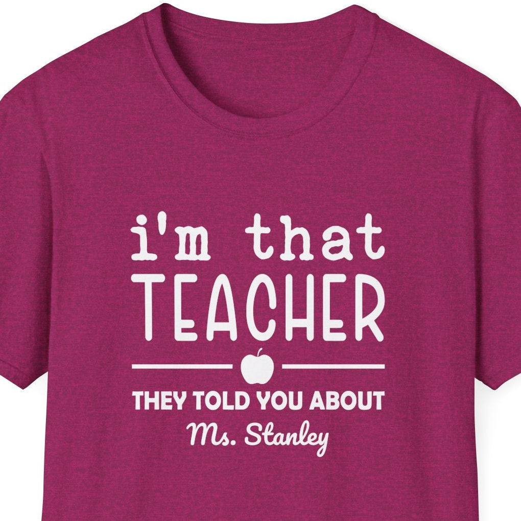 Dark pink t-shirt with 'i'm that teacher they told you about' graphic on a white background