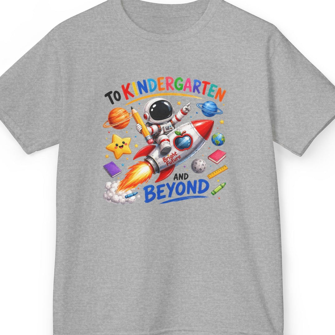 A heather gray short-sleeve t-shirt with a colorful graphic on the front that reads 'TO K NDERGARTEN AND BEYOND' around an astronaut and rocket illustration, shown on a plain white background.