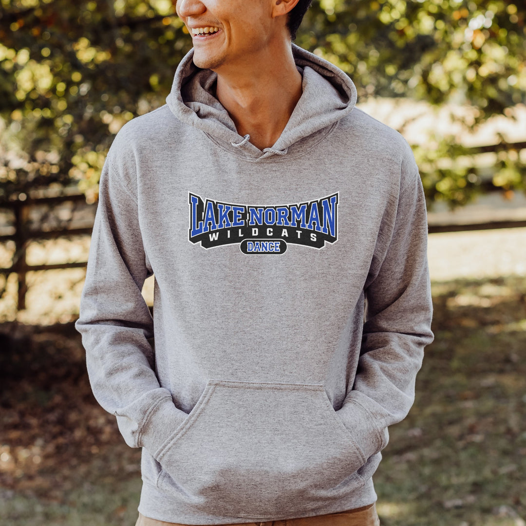 Man wearing an athletic gray hoodie with 'Lake Norman Wildcats Dance' text, standing outdoors. 